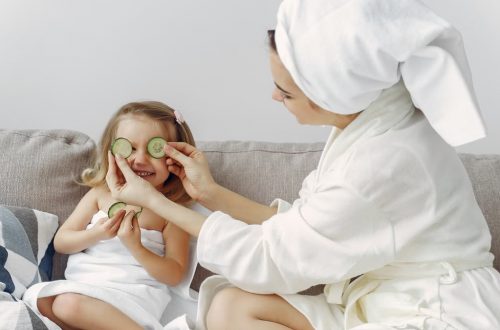A mother and daughter enjoy a relaxing spa day at home with cucumbers and laughter.